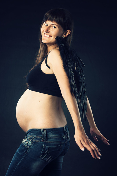 Pregnant woman with black wings - Fotoğraf, Görsel