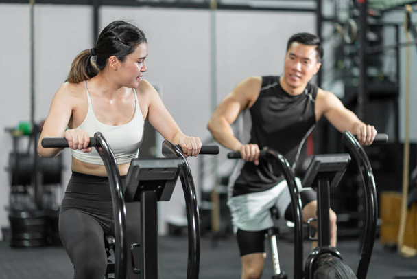 Asian men and women Have a strong body, good health, love to exercise. They are exercising together at the gym having fun.	 - Фото, зображення