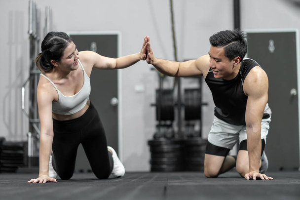 Asian men and women Have a strong body, good health, love to exercise. They are exercising together at the gym having fun.	 - Fotografie, Obrázek