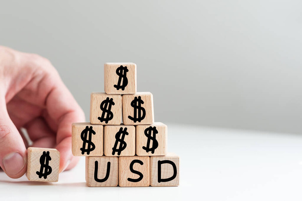 text usdt on vertical row of wooden blocks on the background of columns of numbers. USD text on wooden cubes on blue backround. Business concept. High quality photo - Photo, Image