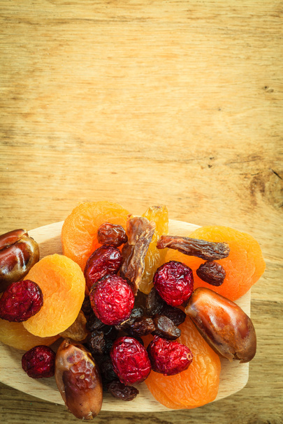 dried fruit on wooden spoon. - Foto, imagen
