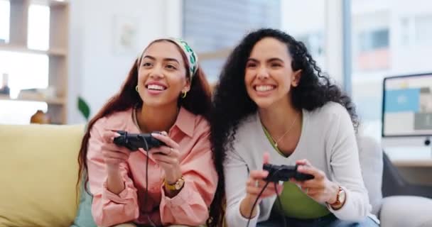 Girl friends, sofa and celebration for gaming together, relax and online challenge in home living room. Women, video game and excited people on couch, lounge and competition with winning in house. - Footage, Video