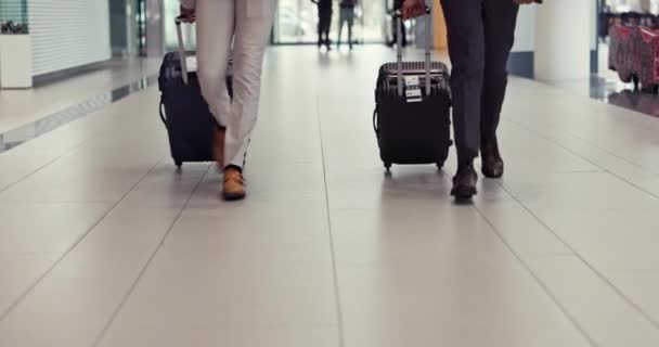 Airport luggage, business people and legs walking for global journey, plane travel or international opportunity. Immigration, flight schedule and closeup team, shoes and steps to airplane booking. - Footage, Video