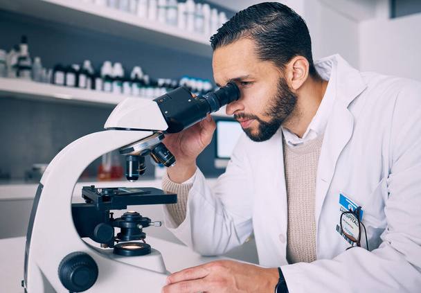 Microscope, research and man scientist looking for sample analysis or experiment in a laboratory for a medical project. Science, equipment and professional test bacteria or DNA in a chemistry lab. - Photo, Image