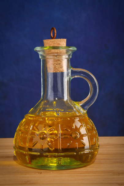 Bottle of oil on blue - Foto, Imagen