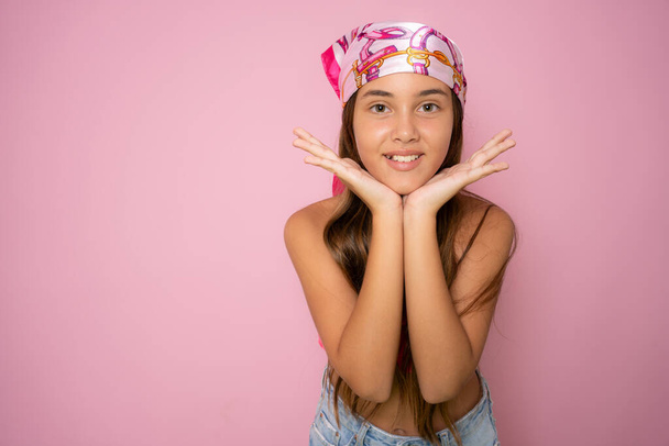Közelkép portré aranyos gyermek lány mosolyog elszigetelt felett rózsaszín háttér. - Fotó, kép