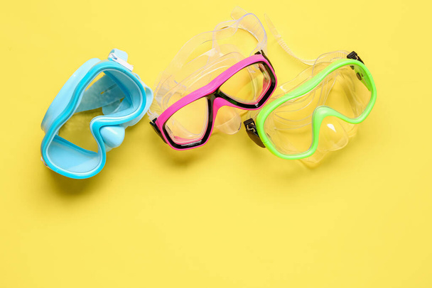Different swimming masks on yellow background - Photo, Image
