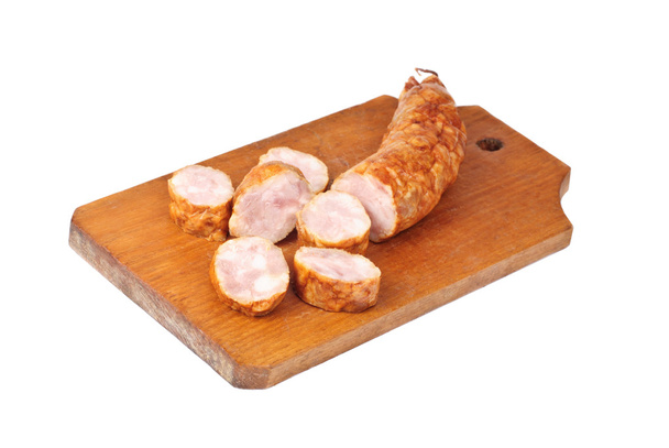 sliced sausage on cutting board isolated on white background  - Photo, Image
