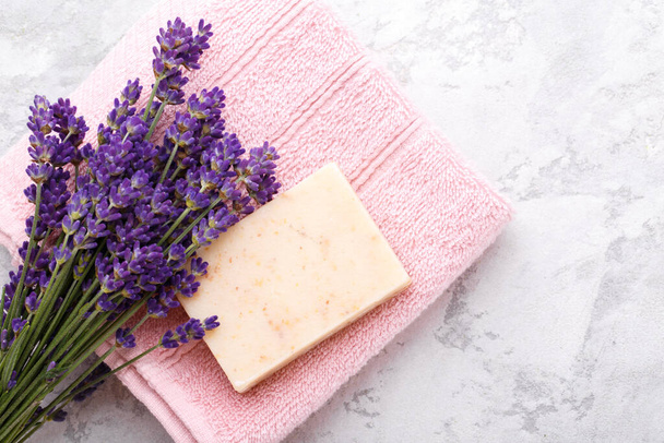 Hand made soap with lavender flowers on the grey stone background flat lay with copy space - Foto, Bild