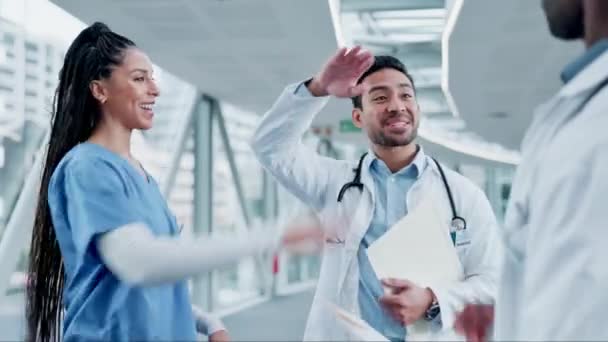Doctors, nurses and high five of teamwork, healthcare success and applause in hospital motivation and clinic support. Medical professional, diversity and group of people with hands together and news. - Footage, Video