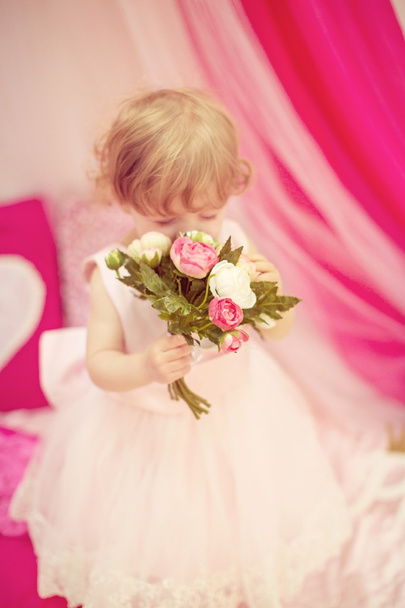 Beautiful little girl with flowers - Photo, Image