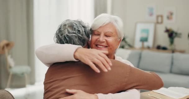 Geluk, gezicht en senior vrienden knuffelen in vriendschap reünie, hechting en genieten van pensioen tijd samen in de huiskamer. Liefde, steun of gelukkige mensen omarmen, verzorgen en glimlachen van oudere vrouwen. - Video