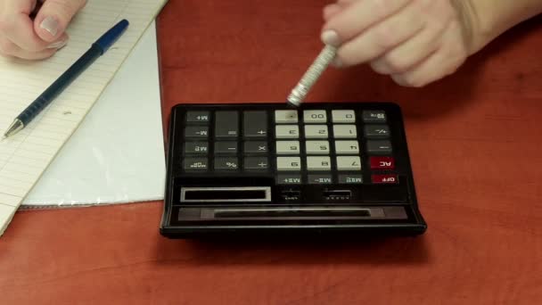 Pencil eraser pushing a calculator keypad - Footage, Video