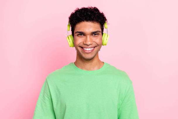 Photo of nice cheerful man wear green trendy clothes listen wireless device song hit soundtrack isolated on pink color background. - Foto, afbeelding