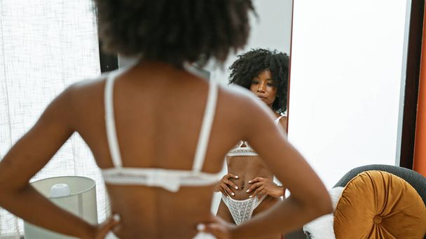 Afričanky americká žena spodní prádlo model při pohledu na zrcadlo pózování doma - Fotografie, Obrázek
