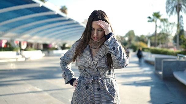 Beautiful hispanic woman standing with worried expression at park - Photo, Image