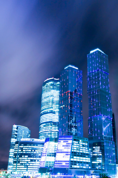Contemporary construction of illuminated office glass skyscraper - Photo, Image