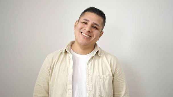 Young hispanic man smiling confident standing over isolated white background - Фото, изображение