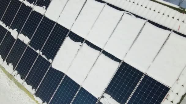 Aerial view of house roof with solar panels covered with snow melting down in winter end for producing clean energy. Concept of low effectivity of renewable electricity in northern region. - Metraje, vídeo