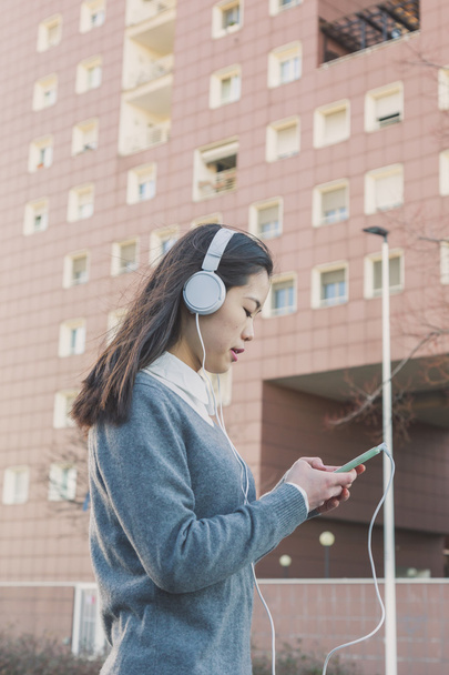 Young beautiful Chinese girl with headphones - Photo, Image