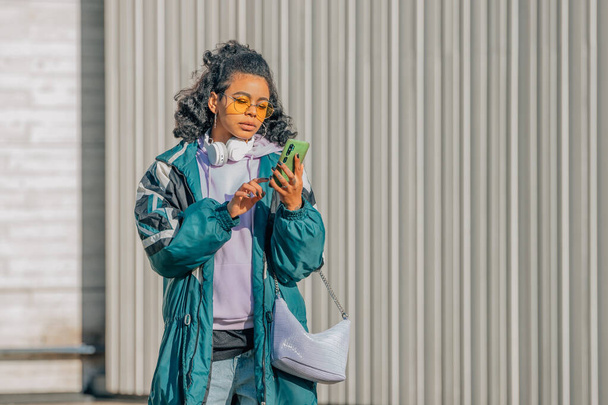 girl on the street with mobile phone or smartphone - Φωτογραφία, εικόνα