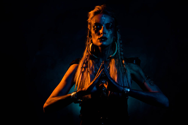 Photo of wild dangerous lady wear viking clothes praying death gods isolated dark orange blue color background. - Photo, Image