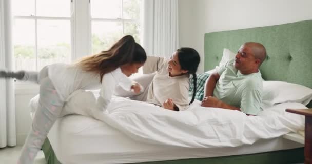 Family, bed and tickle in morning with laugh and bonding in a home from above. Young girl, parent love and care in a house on bedroom with mother, father and daughter together with a happy smile. - Záběry, video