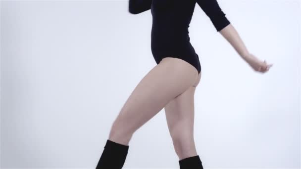 Legs of a modern dancer with black body costume wearing knee-highs. - Imágenes, Vídeo