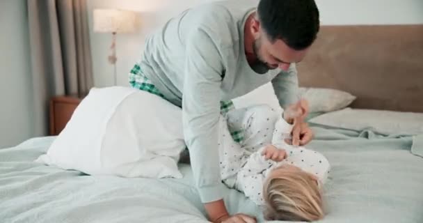Family, bedroom and father playing with child for bonding, relaxing and quality time together. Love, home and happy dad with daughter laughing on bed for cuddle, tickle and happiness in morning. - Footage, Video
