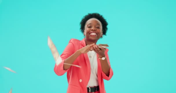 Black woman, winner and celebration with money in hands in studio, blue background and spending cash, prize and wealth. Lottery, bonus and dance with dollars in casino or businesswoman with profit. - Imágenes, Vídeo