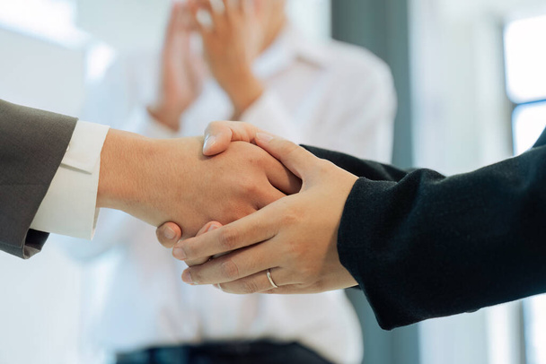 Closeup Handshake of employees after successful planning strategy marketing in the office. - Photo, Image