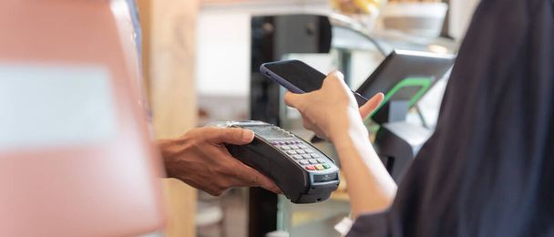 Woman use smartphone to scan QR code to pay in cafe restaurant with a digital payment without cash. Choose menu and order accumulate discount. E wallet, technology, pay online, credit card, bank app. - Photo, Image