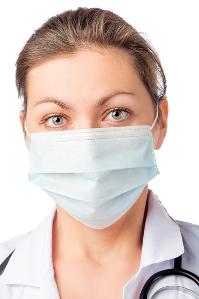 mulher cirurgião em máscara médica em seu rosto em um fundo branco
 - Foto, Imagem