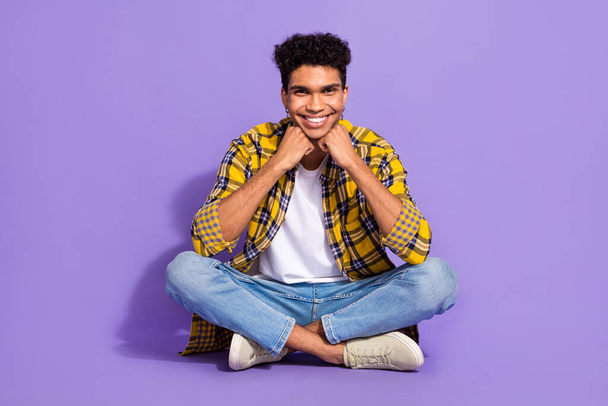 Full length portrait of cheerful peaceful person sit floor hands touch chin good mood isolated on purple color background. - Fotografie, Obrázek
