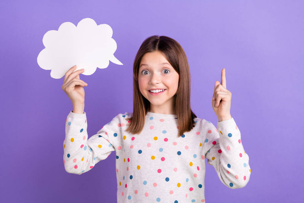 Photo of shiny excited little girl dressed dotted pullover pointing finger rising mind cloud empty space isolated purple color background. - Fotó, kép