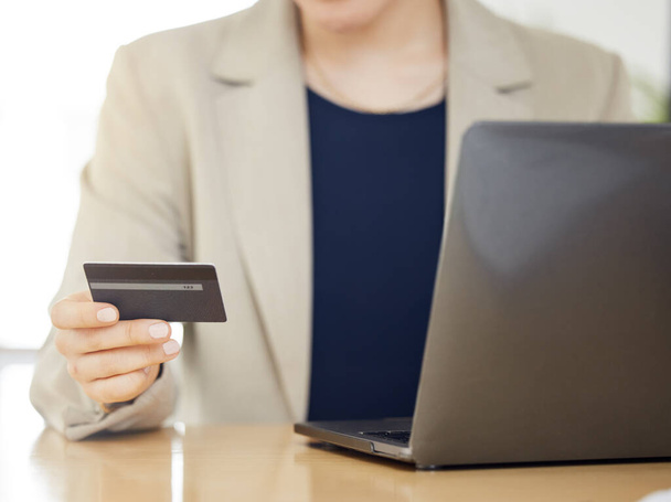 Online winkelen, creditcard en zakenvrouw met betaling op een internet of bankieren op een laptop. Handen, leningen en zakelijke professionele of klantengebruik beloningen te kopen op e-commerce website. - Foto, afbeelding