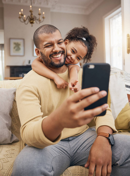 Home, father and girl with a smile, selfie and social media with connection, family and loving together. People, parent and female child on a couch, profile picture and memory with happiness and love. - Foto, Imagen