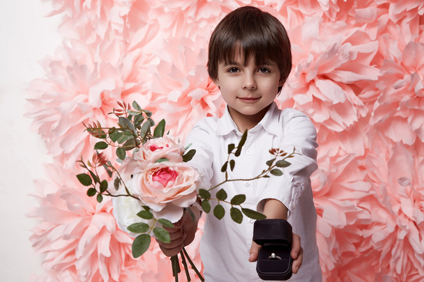 Handsome boy with flower and jewelry box ring with diamond - Valokuva, kuva