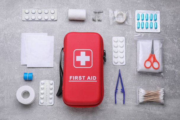 Flat lay composition with first aid kit on light gray background - Фото, зображення