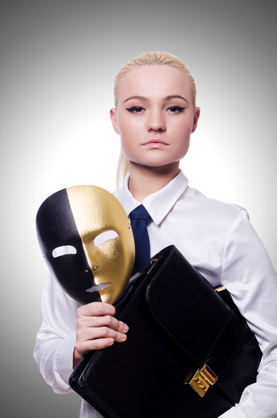 Woman with mask in hypocrisy concept - Photo, Image