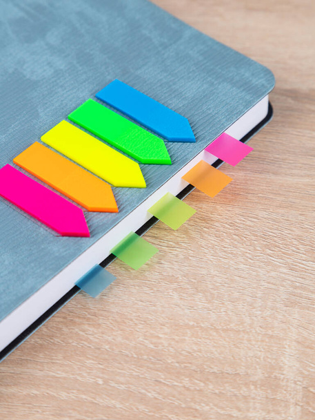 Close-up of multi-colored bookmarks in a gray notepad - Photo, Image