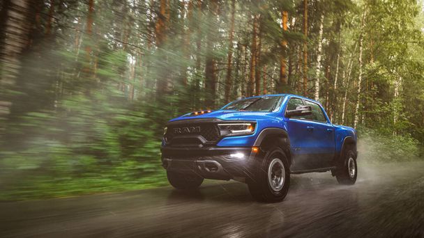  Novosibirsk, Russia - July 27, 2023:  blue  Dodge Ram Trx Havok Edition, pickup  driving   on the street on a warm day against the backdrop of a forest - Photo, Image