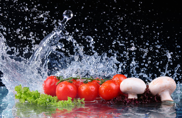 Red tomato cherry, mushrooms and green fresh salad with water drop splash - Photo, image
