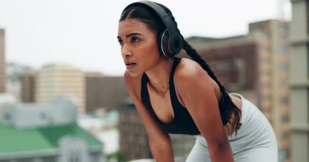 Fitness, headphones and woman breathe in city for training, running and exercise outdoors. Sports, rest and female person listening to music, track and radio for healthy body, wellness and workout. - Footage, Video