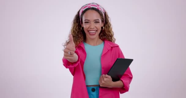 Happy woman, tablet and thumbs up in good job, winning or success against a studio background. Portrait of female person smile with technology and like emoji, yes sign or OK in agreement on mockup. - Footage, Video