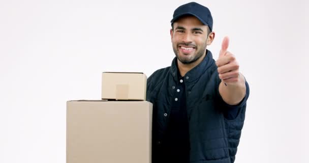 Happy man, box and thumbs up in delivery, thank you or approval success against a grey studio background. Portrait of male person or courier guy smile with like emoji, yes sign or OK for supply chain. - Footage, Video