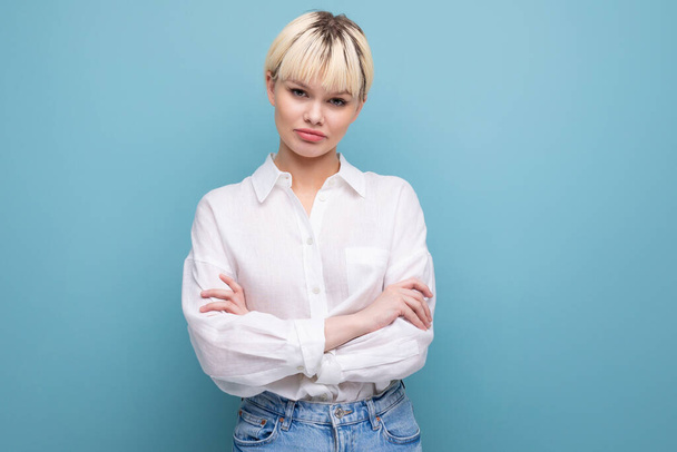 portrait of a young blond business woman with a short haircut in a white shirt on a background with copy space. - Photo, Image