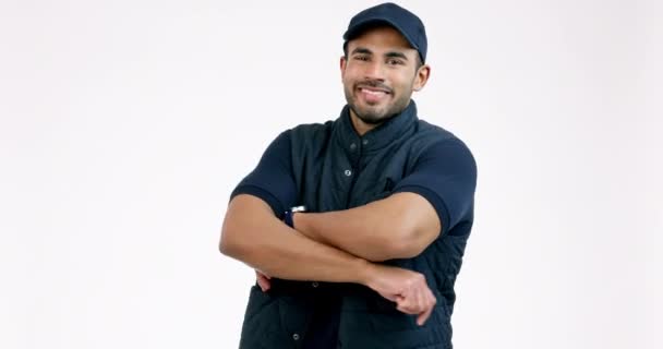 Happy man, delivery and arms crossed of professional in customer service against a grey studio background. Portrait of confident male person or courier guy smile in supply chain industry or transport. - Footage, Video