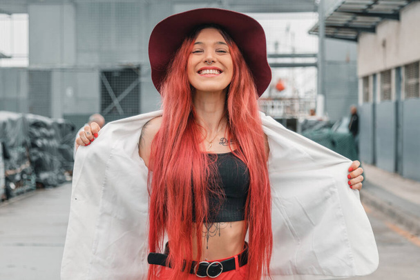 hipster girl with hat and red hair smiling on the street - Photo, Image