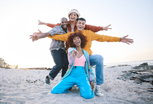 Friends, beach and portrait of excited people outdoor for travel motivation or fun on sand. Diversity, happiness and gen z group of men and women pointing for adventure, holiday and freedom in nature. - Photo, Image